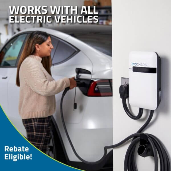 A woman charges her EV inside her garage using an EvoCharge Level 2 charger.