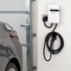 Closeup photo of a Evo Charger mounted on a garage wall.