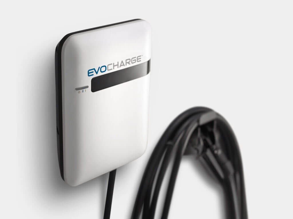 An EvoCharge charger hung up on a white wall
