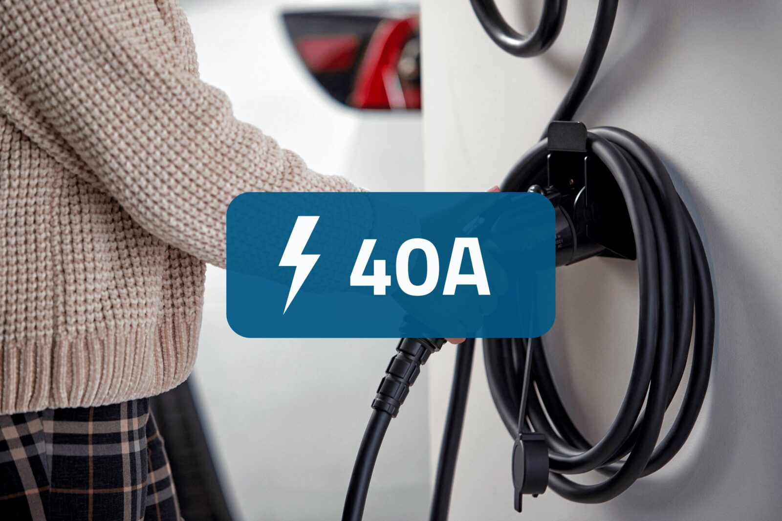 Woman grabbing EV charger with a blue box overlaying the image saying "40A".