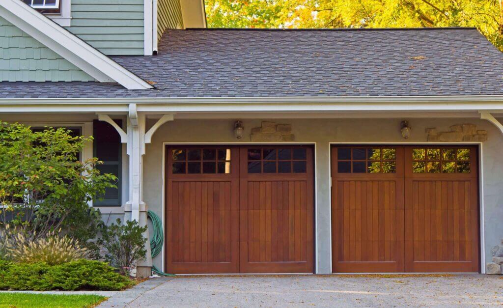 Photo of double garage doors on a nice day.